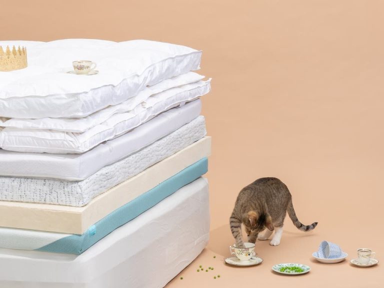 Waterproof mattress protector fitted over a quilted pillow top mattress in a bright bedroom