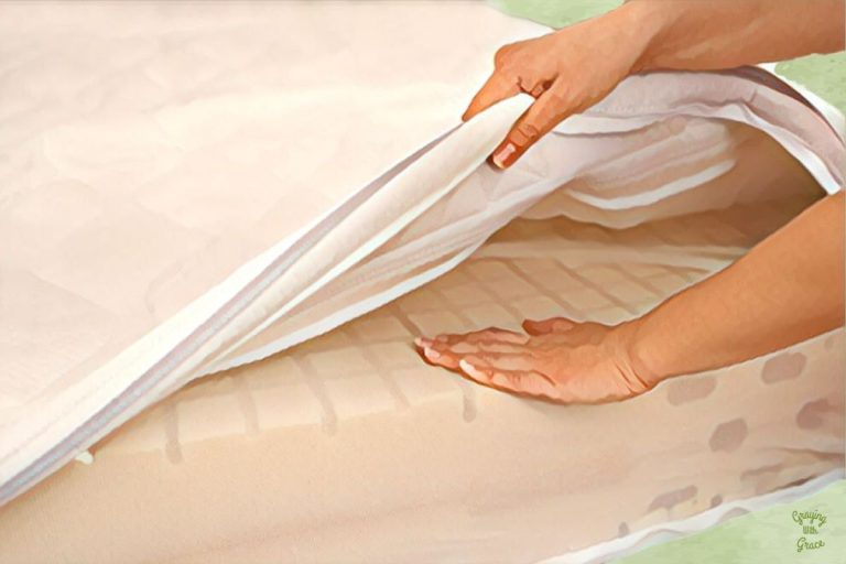 White quilted mattress protector on an adjustable bed raised in a bright bedroom